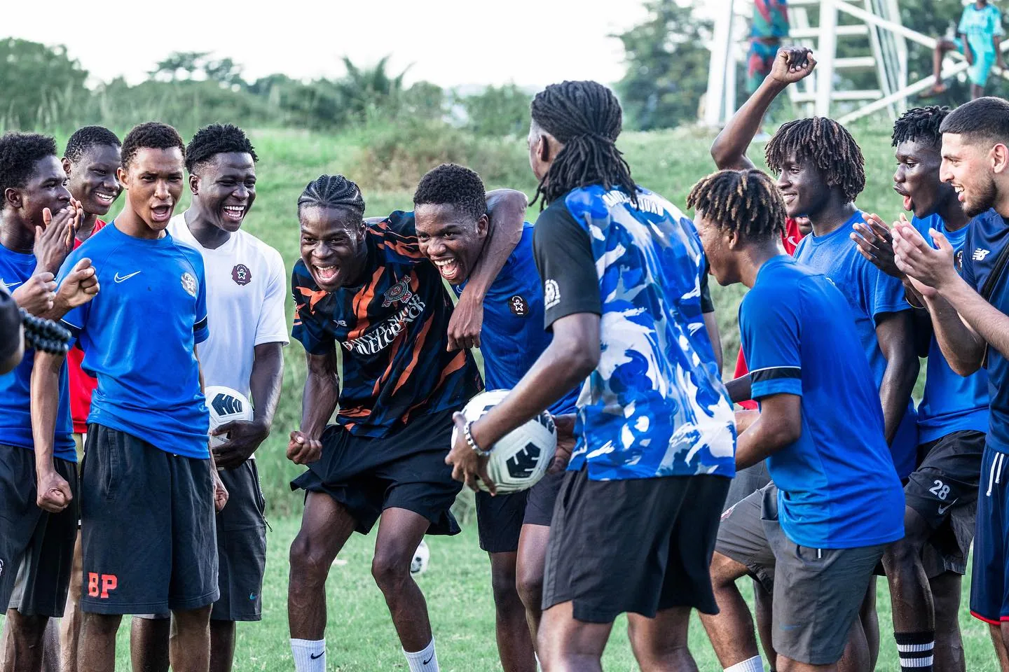 Baiteze players gathered on a football pitch